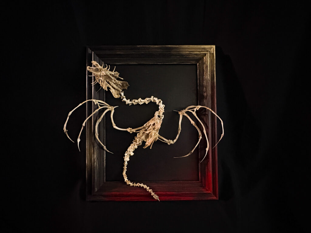 Full image of the Beithir serpent skeleton coiling around a natural driftwood base, highlighting the marriage of bone and nature.